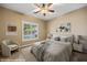 Comfortable bedroom with a ceiling fan, neutral paint, a large window with shutters and stylish staging at 1561 Campfire Ln, Mesquite, NV 89034