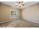 Cozy bedroom with carpet, neutral paint, ceiling fan, and a window with shutters at 1561 Campfire Ln, Mesquite, NV 89034