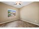 Tile-floored bedroom with neutral paint, a ceiling fan, and a window with a serene desert view at 1561 Campfire Ln, Mesquite, NV 89034