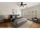 Comfortable bedroom with large windows, neutral decor, and a ceiling fan at 1561 Campfire Ln, Mesquite, NV 89034