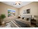 Relaxing staged bedroom featuring stylish decor, neutral colors, and a window view at 1561 Campfire Ln, Mesquite, NV 89034