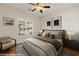Inviting bedroom featuring a queen bed, bedside tables, and a sitting chair at 1561 Campfire Ln, Mesquite, NV 89034
