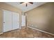 Cozy bedroom featuring neutral walls, ceiling fan and a closet with white double doors at 1561 Campfire Ln, Mesquite, NV 89034