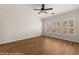 Bright bedroom with hardwood floors, ceiling fan and white shuttered windows at 1561 Campfire Ln, Mesquite, NV 89034