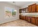 Dining area featuring dark wood cabinets and a view of the landscaped yard at 1561 Campfire Ln, Mesquite, NV 89034