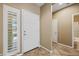 Bright entryway featuring tile flooring, neutral paint, and a paneled front door with sidelight at 1561 Campfire Ln, Mesquite, NV 89034