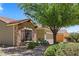 View of a charming single-story home featuring stone accents, desert landscaping, and a well-maintained front yard at 1561 Campfire Ln, Mesquite, NV 89034