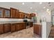 Bright kitchen showcasing dark wood cabinetry, granite countertops, and stainless steel appliances at 1561 Campfire Ln, Mesquite, NV 89034