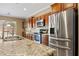 Kitchen featuring stainless steel refrigerator and appliances, granite countertops and wooden cabinets at 1561 Campfire Ln, Mesquite, NV 89034