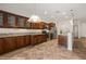 Spacious kitchen with stainless steel appliances, dark wood cabinets, and a breakfast bar at 1561 Campfire Ln, Mesquite, NV 89034
