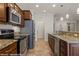 Open-concept kitchen featuring stainless steel appliances and granite countertops at 1561 Campfire Ln, Mesquite, NV 89034