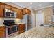 Kitchen featuring stainless steel appliances, granite countertops, and wooden cabinets at 1561 Campfire Ln, Mesquite, NV 89034