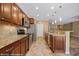 Well-equipped kitchen showcasing stainless steel appliances, granite countertops, and warm wood cabinetry at 1561 Campfire Ln, Mesquite, NV 89034