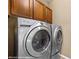 Front load Whirlpool washer and dryer with dark wood cabinets at 1561 Campfire Ln, Mesquite, NV 89034