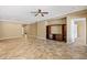 Spacious living room with tiled floors, ceiling fan, and a large built-in entertainment center, perfect for relaxation at 1561 Campfire Ln, Mesquite, NV 89034