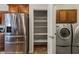 Kitchen pantry with stainless steel refrigerator and a view of the washer and dryer at 1561 Campfire Ln, Mesquite, NV 89034