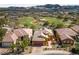 Scenic aerial view of beautiful homes with manicured lawns and a golf course in the background under a clear sky at 16 Cerchio Basso, Henderson, NV 89011