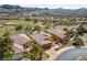 Aerial view shows houses with golf course and mountain views and palm trees, in a planned community at 16 Cerchio Basso, Henderson, NV 89011