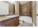 Bathroom featuring a vanity with granite countertop, white sink, tile backsplash, and a tub-shower combo at 16 Cerchio Basso, Henderson, NV 89011
