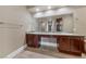 Bathroom vanity featuring double sinks, granite countertops and dark wood cabinets at 16 Cerchio Basso, Henderson, NV 89011