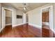 Large bedroom with wood floors, ceiling fan, TV, walk-in closet, and ensuite bathroom at 16 Cerchio Basso, Henderson, NV 89011