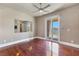 Bedroom with wood floors, ceiling fan, mirror, and access to a balcony with mountain views at 16 Cerchio Basso, Henderson, NV 89011