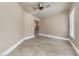Bedroom with neutral walls, ceiling fan, and plantation shutters at 16 Cerchio Basso, Henderson, NV 89011