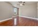 Spacious bedroom with polished wood floors, large window, and ceiling fan at 16 Cerchio Basso, Henderson, NV 89011