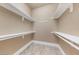 Walk-in closet with built-in shelving and tile flooring at 16 Cerchio Basso, Henderson, NV 89011