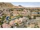 Scenic aerial view of a residential community nestled against a mountain backdrop with vibrant landscaping at 16 Cerchio Basso, Henderson, NV 89011