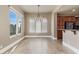 Bright dining area with chandelier, large windows, and access to kitchen at 16 Cerchio Basso, Henderson, NV 89011