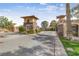 Elegant gated community entrance with stone and stucco detailing, featuring manicured landscaping and secure access at 16 Cerchio Basso, Henderson, NV 89011