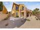 Two-story home with stone accents, a balcony, and landscaped front yard, creating curb appeal at 16 Cerchio Basso, Henderson, NV 89011