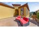 Front entrance featuring a covered patio area with outdoor seating and desert views at 16 Cerchio Basso, Henderson, NV 89011