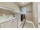 Well-organized laundry room featuring a sink and modern washer and dryer for convenience at 16 Cerchio Basso, Henderson, NV 89011