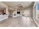 Spacious living room featuring a fireplace, tile flooring, and access to the balcony at 16 Cerchio Basso, Henderson, NV 89011