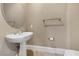 Elegant powder room featuring a pedestal sink and neutral color palette for a clean and sophisticated look at 16 Cerchio Basso, Henderson, NV 89011