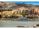 Scenic waterfront view with luxurious apartments, docked yacht, and mountains, creating a picturesque landscape at 16 Cerchio Basso, Henderson, NV 89011