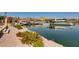 Picturesque waterfront with docks, boats, and lakeside buildings reflecting in calm waters, enhanced by lush landscaping at 16 Cerchio Basso, Henderson, NV 89011