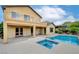 Backyard with a covered patio, a pool, a spa and second story balcony at 17 Stonemark Dr, Henderson, NV 89052