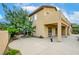 Charming home featuring a covered patio, verdant landscaping, and a stone pathway leading to the backyard at 17 Stonemark Dr, Henderson, NV 89052
