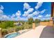 Balcony with stunning views of neighborhood homes and a crystal-clear swimming pool at 17 Stonemark Dr, Henderson, NV 89052