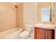 Cozy bathroom showcasing a shower-tub combination and a vanity with wooden cabinet at 17 Stonemark Dr, Henderson, NV 89052