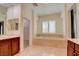 A stylish bathroom with dual sinks, soaking tub, and a separate walk-in shower with nice cabinets at 17 Stonemark Dr, Henderson, NV 89052
