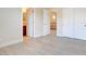 Bright bedroom featuring light-colored floors and view of second story landing and bathroom at 17 Stonemark Dr, Henderson, NV 89052