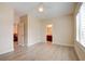 Inviting bedroom with light hardwood floors and views to the staircase and bathroom at 17 Stonemark Dr, Henderson, NV 89052