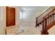 Welcoming foyer with decorative tile inlay, wood staircase, hardwood floors, and natural light, creating an inviting entrance at 17 Stonemark Dr, Henderson, NV 89052