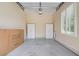 Clean, unfinished garage interior, featuring lots of storage shelves and a large window for natural light at 17 Stonemark Dr, Henderson, NV 89052