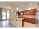 Gourmet kitchen with granite counters, stainless appliances, and an open view to the backyard at 17 Stonemark Dr, Henderson, NV 89052