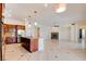 Spacious kitchen with stainless steel appliances, granite counters, and open view of the living room and fireplace at 17 Stonemark Dr, Henderson, NV 89052